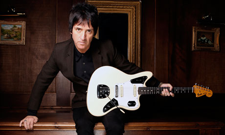 Johnny Marr holding his guitar to perform a 30-date concert tour in Europe